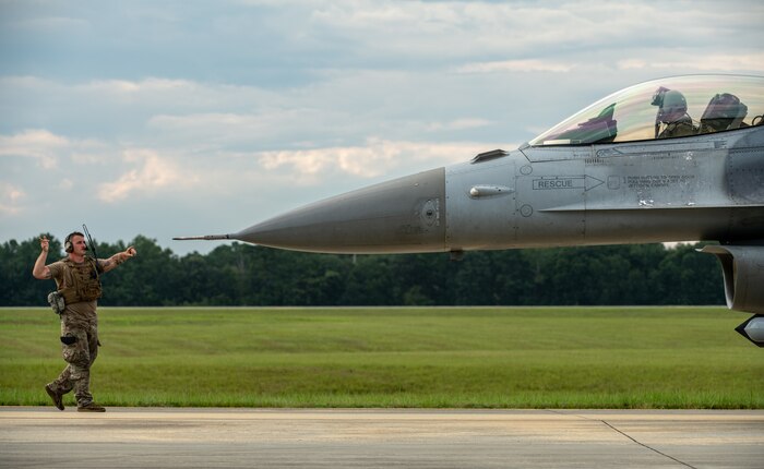 An Airman directs an F-16.