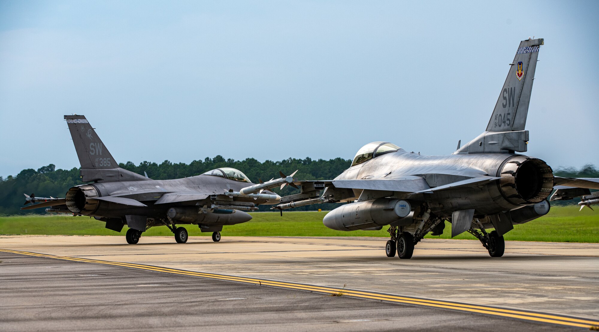 Two F-16s prepare for take off.