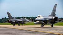 Two F-16s prepare for take off.