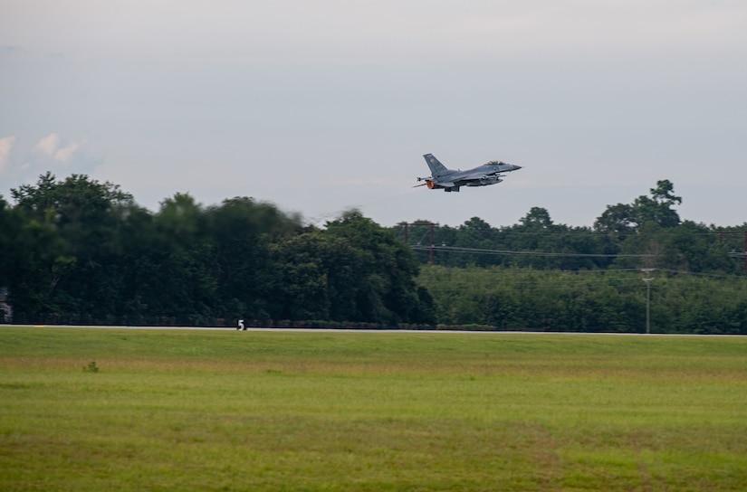 An F-16 takes off on a runway.