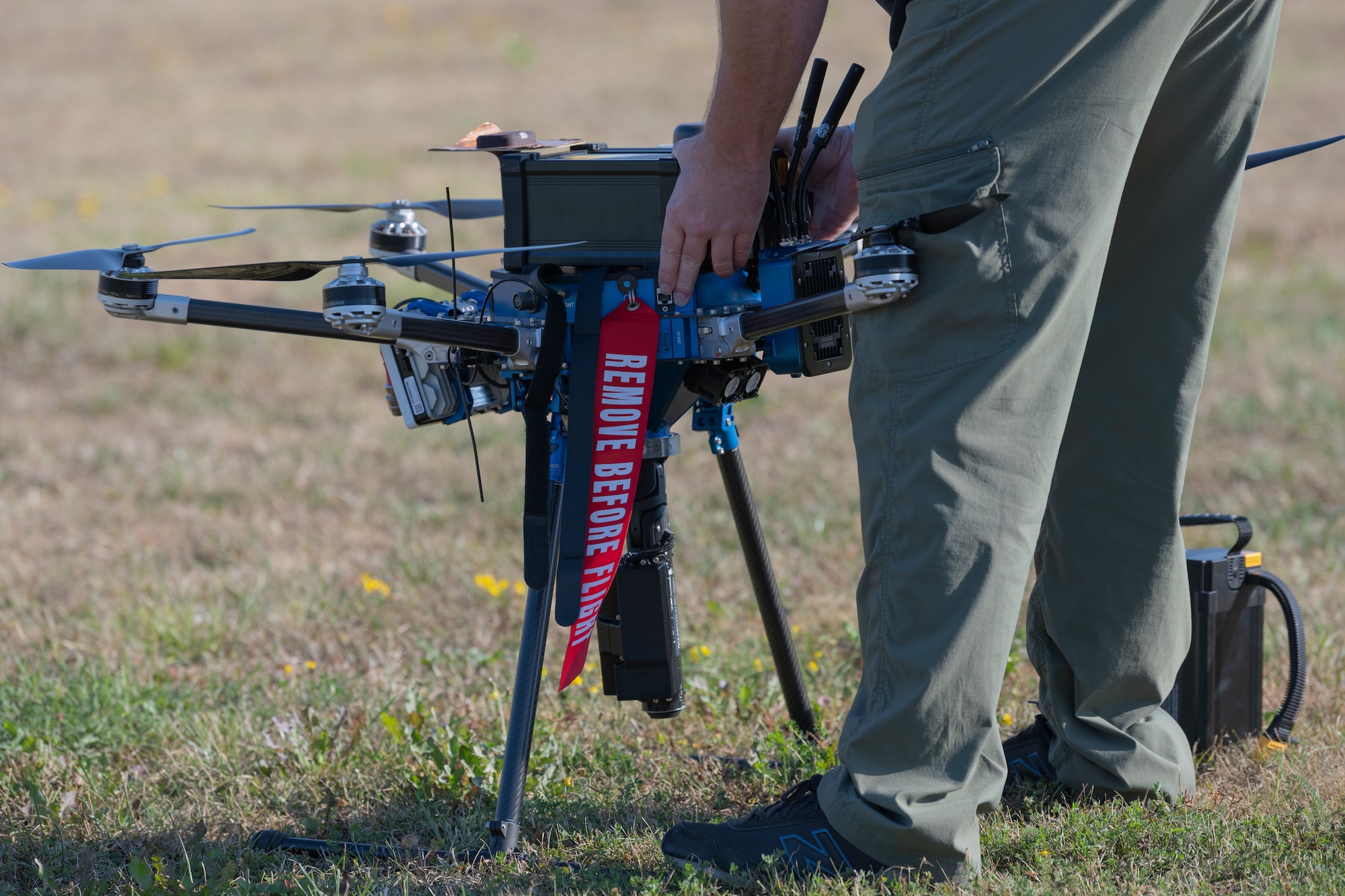 Contractor prepares drone for flight.