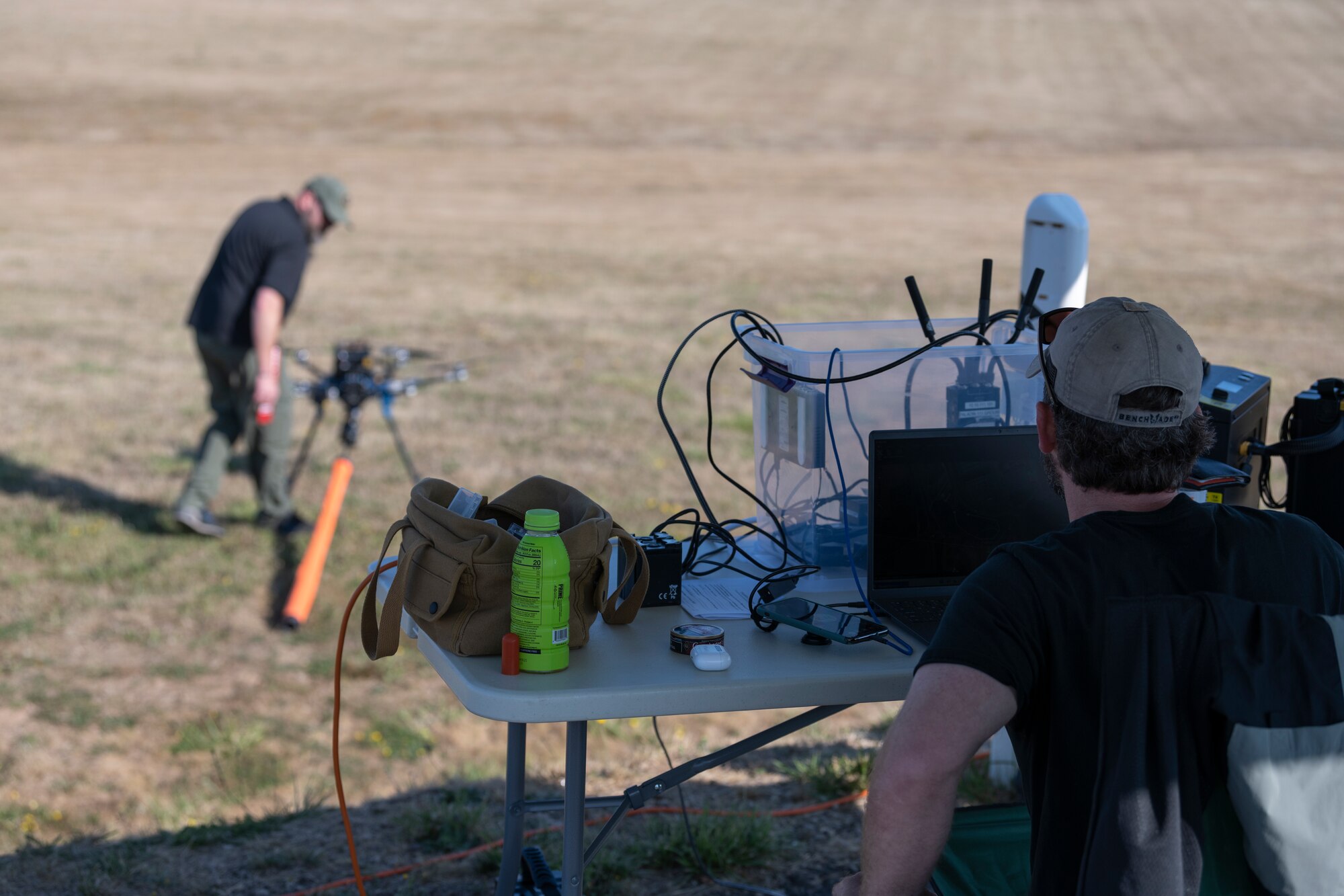 Contractors prepare a drone for flight.