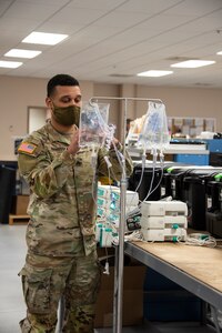 Staff Sgt. Cody Harrison, a biomedical equipment specialist stationed at the U.S. Army Medical Materiel Agency’s Medical Maintenance Operations Division at Hill Air Force Base, Utah, works on a portable transfusion pump. (Katie Ellis-Warfield)