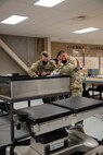 Soldiers stationed at the U.S. Army Medical Materiel Agency’s Medical Maintenance Operations Division at Hill Air Force Base, Utah, work on a medical device. (Katie Ellis-Warfield)