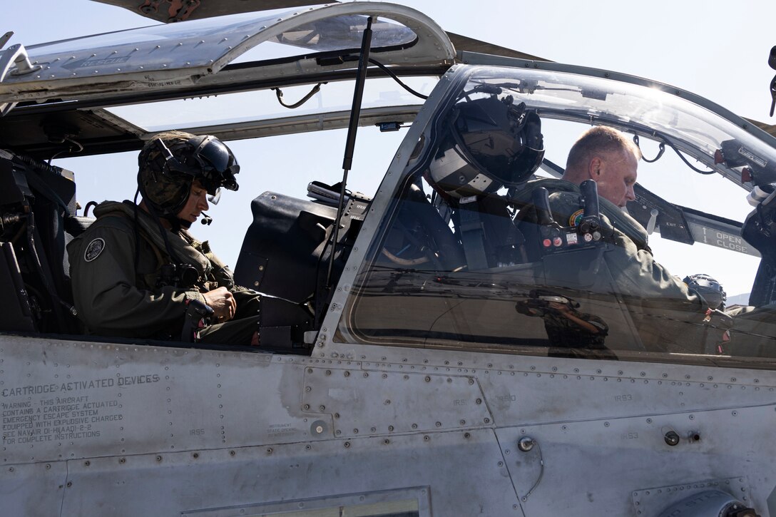 U.S. Marine Corps Capt. Jacob Gillespie, an AH-1Z Viper pilot from Marine Light Attack Helicopter Squadron 369, Marine Aircraft Group 39, 3rd Marine Aircraft Wing, left, and Lt. Gen. Steven R. Rudder, commander, U.S. Marine Corps Forces, Pacific, prepare for the general’s final flight at Marine Corps Air Station Camp Pendleton, California, Aug. 25, 2022. The flight marked a significant occasion for Rudder, who is retiring after 38 years of service from the world's most elite fighting force. Since 2020, Rudder has commanded two-thirds of the Marine Corps’ operating forces committed to preserving a free and open Indo-Pacific region. Rudder is a native of Canton, Connecticut and Gillespie is a native of Fayetteville, Arkansas. (U.S. Marine Corps photo by Sgt. Rachaelanne Woodward)