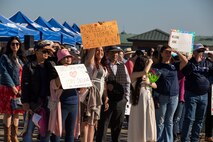 Families and friends hold signs for Sailors assigned to Arleigh Burke-class guided-missile destroyer USS Momsen (DDG 92), on pier at Naval Station Everett, Washington, Sept. 6. The Momsen, assigned to Carrier Strike Group Three, returned to Naval Base Everett following an a seven-month deployment to the U.S. 3rd, 5th and 7th Fleets in support of a free and open Indo-Pacific. (U.S. Navy photo by Mass Communication Specialist 2nd Class Ethan Soto)