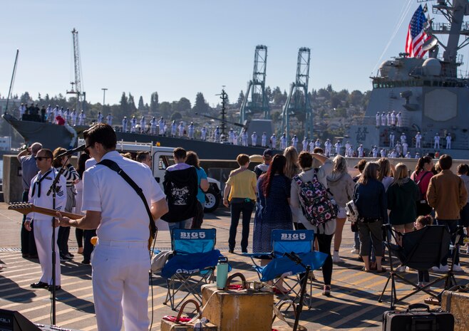 Chief Musician Robert Taylor, attached to Navy Band Northwest, plays guitar during Arleigh Burke-class guided-missile destroyer USS Momsen's (DDG 92) homecoming to Naval Station Everett, Washington, Sept. 6. The Momsen, assigned to Carrier Strike Group Three, returned following a seven-month deployment to the U.S. 3rd, 5th and 7th Fleets in support of a free and open Indo-Pacific. (U.S. Navy photo by Mass Communication Specialist 2nd Class Ethan Soto)