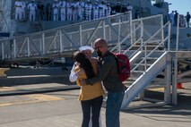 A Sailor assigned to Arleigh Burke-class guided-missile destroyer USS Momsen (DDG 92) reuintes with her family on pier at Naval Station Everett, Washington, Sept. 6. The Momsen, assigned to Carrier Strike Group Three, returned following a seven-month deployment to the U.S. 3rd, 5th and 7th Fleets in support of a free and open Indo-Pacific. (U.S. Navy photo by Mass Communication Specialist 2nd Class Ethan Soto)