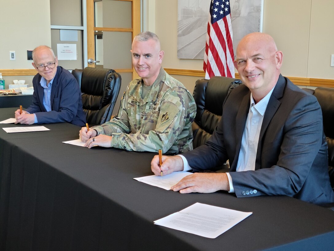 Army Col. Michael Helton, Portland District commander (center), Dan Stahl, Port of Longview chief executive officer (left), and Patrick Harbison, Port of Kalama commission president (right), prepare to sign an agreement for a $2.1 million study, Sept. 6 at the Port of Kalama, Washington. The study will investigate what changes or improvements engineers can make to turning basins in the Columbia River to help larger, deeper-drafting vessels, safely navigate when turning.