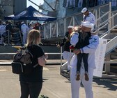 A Sailor assigned to Arleigh Burke-class guided-missile destroyer USS Momsen (DDG 92) reuintes with his family on pier at Naval Station Everett, Washington, Sept. 6. The Momsen, assigned to Carrier Strike Group Three, returned following a seven-month deployment to the U.S. 3rd, 5th and 7th Fleets in support of a free and open Indo-Pacific. (U.S. Navy photo by Mass Communication Specialist 2nd Class Ethan Soto)