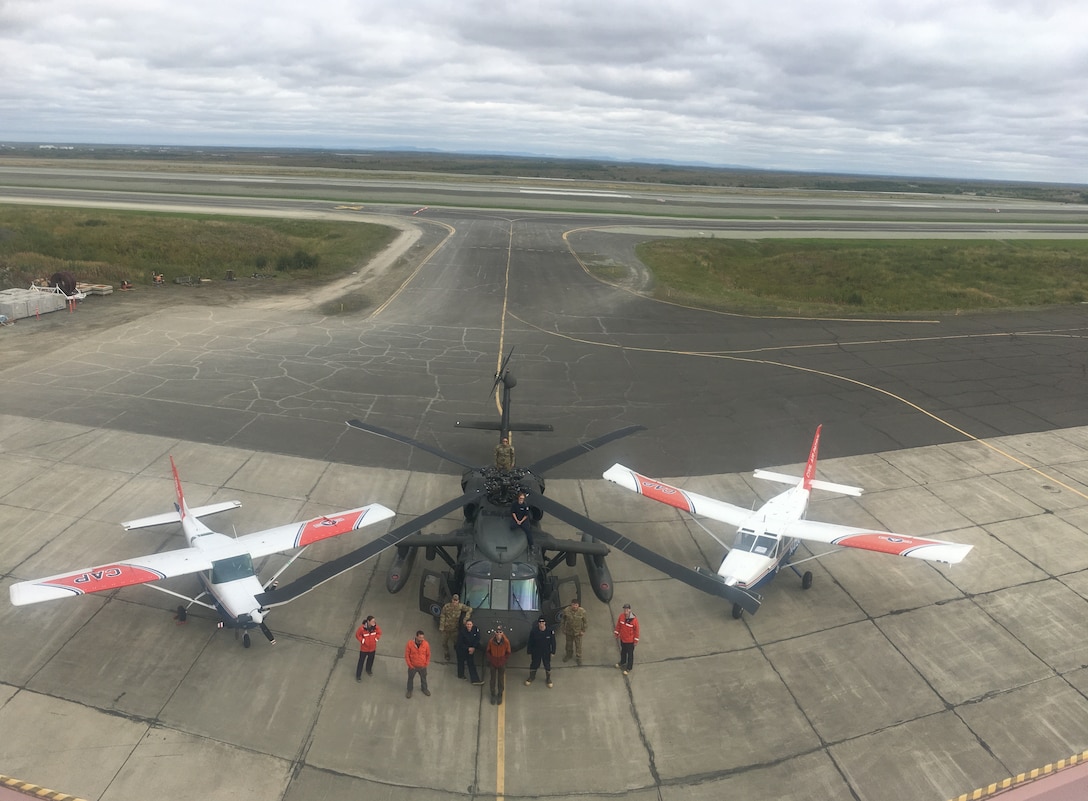 Civil Air Patrol Cessna 206 and GippsAero GA8 Airvan park next to an Alaska Army National Guard UH-60 Black Hawk in front of the Army Guard’s hangar. The CAP and ARNG recently teamed up to support the U.S. Coast Guard’s Operation Arctic Shield, a mission to conduct inspections of approximately 50 bulk fuel storage facilities across Western Alaska, August 22-30.