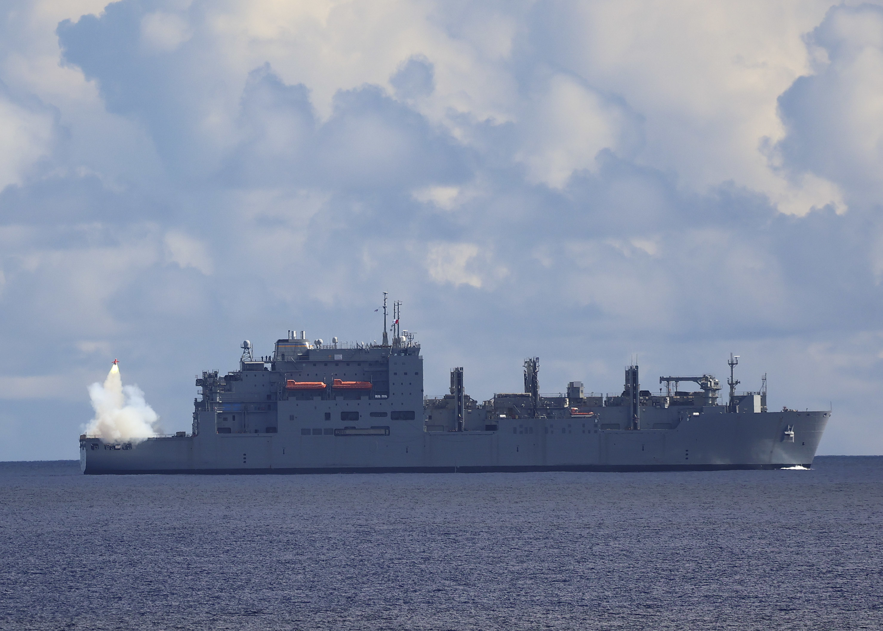 The Military Sealift Command Lewis and Clark-class dry cargo and ammunition ship USNS Alan Shepard (T-AKE 3) launches a drone during an SM-2 Standard Missile exercise conducted with the Arleigh Burke-class guided-missile destroyer USS Barry (DDG 52) as part of Pacific Vanguard (PV) 22 while operating in the Philippine Sea.