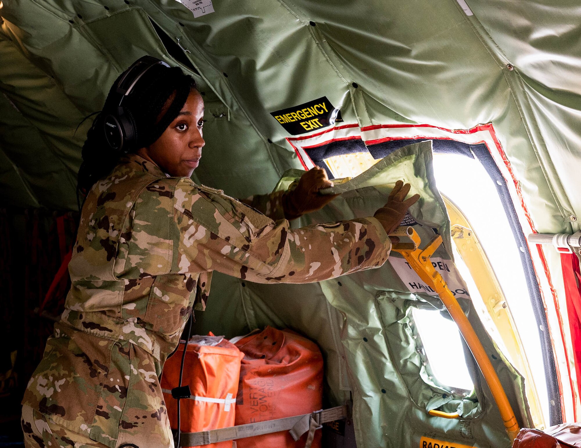 Airman 1st Class Lahjahniek Ramdene, 340th Expeditionary Air Refueling Squadron aerial refueling specialist, secures an aircrew escape hatch on a KC-135 Stratotanker before a Bomber Task Force mission, at Al Udeid Air Base, Qatar, Sept 4, 2022. BTF missions demonstrate the U.S.’s commitment to regional security and stability by showing how the U.S. will decisively respond to threats against U.S., coalition and partner forces.  (U.S. Air Force photo by Staff Sgt. Dana Tourtellotte)