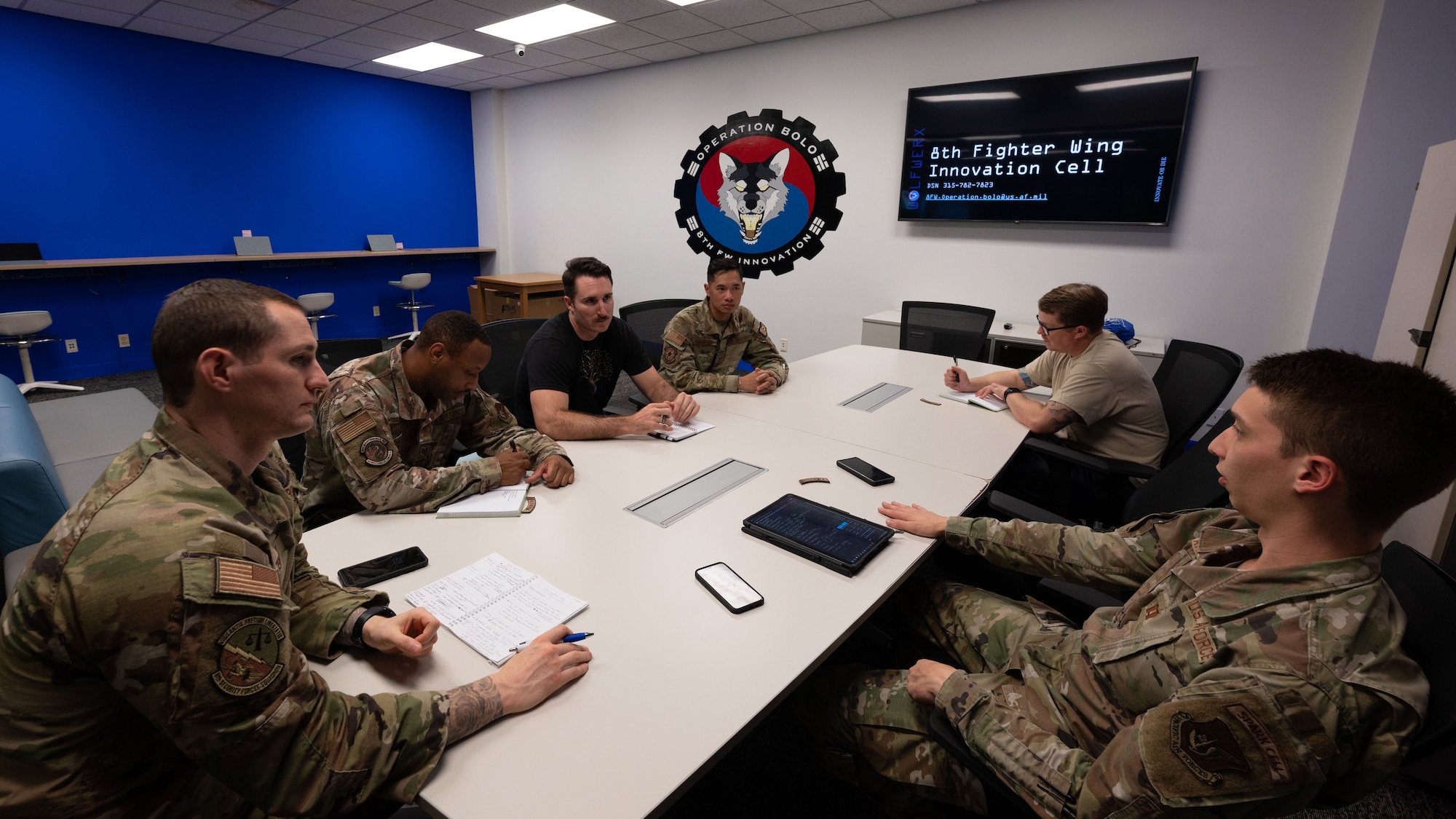 A group of Airmen have a meeting and discuss ideas on how to make WOLFWERX better.