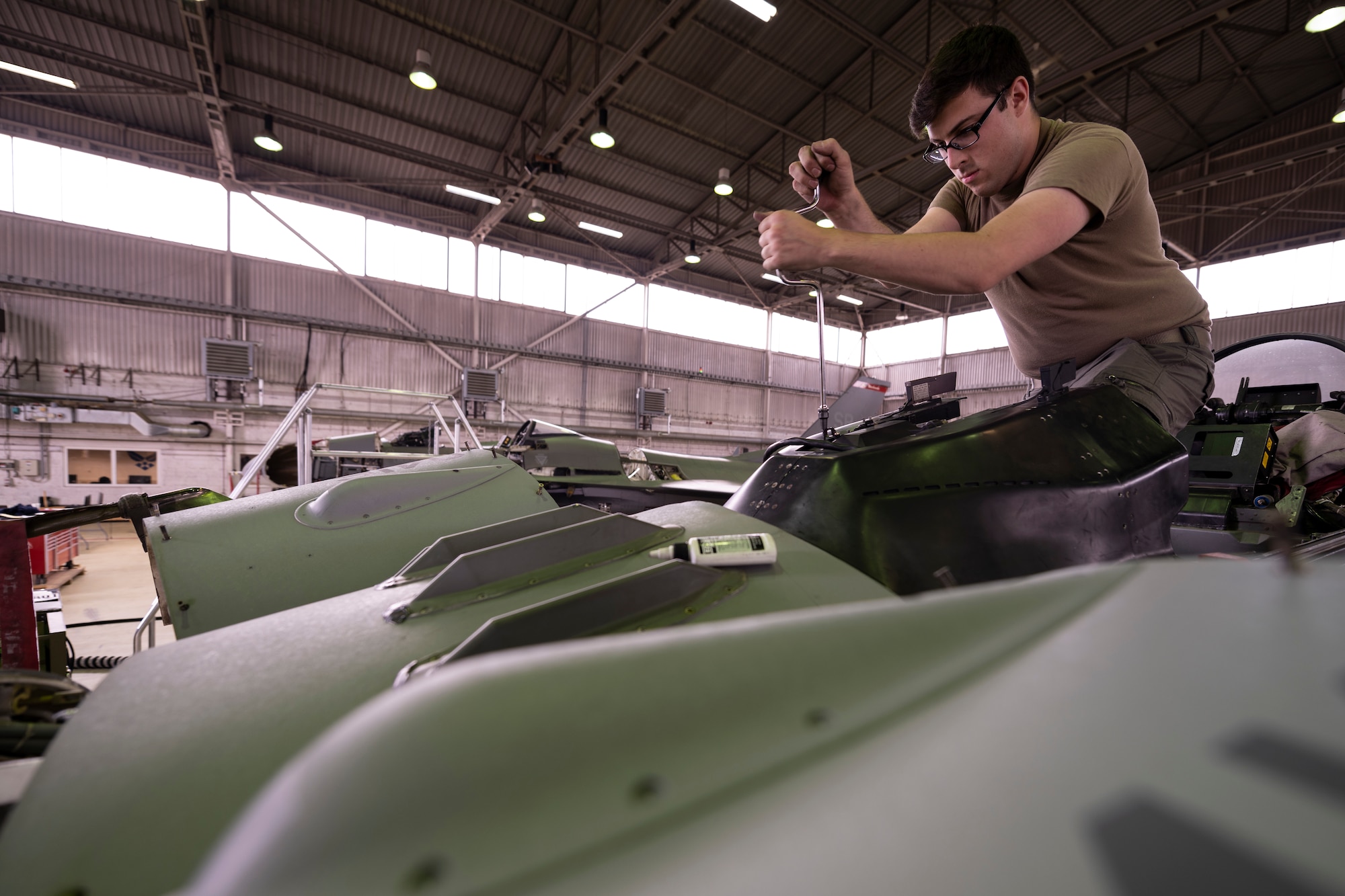 U.S. Air Force Airman performs maintenance on an F-16C Fighting Falcon.