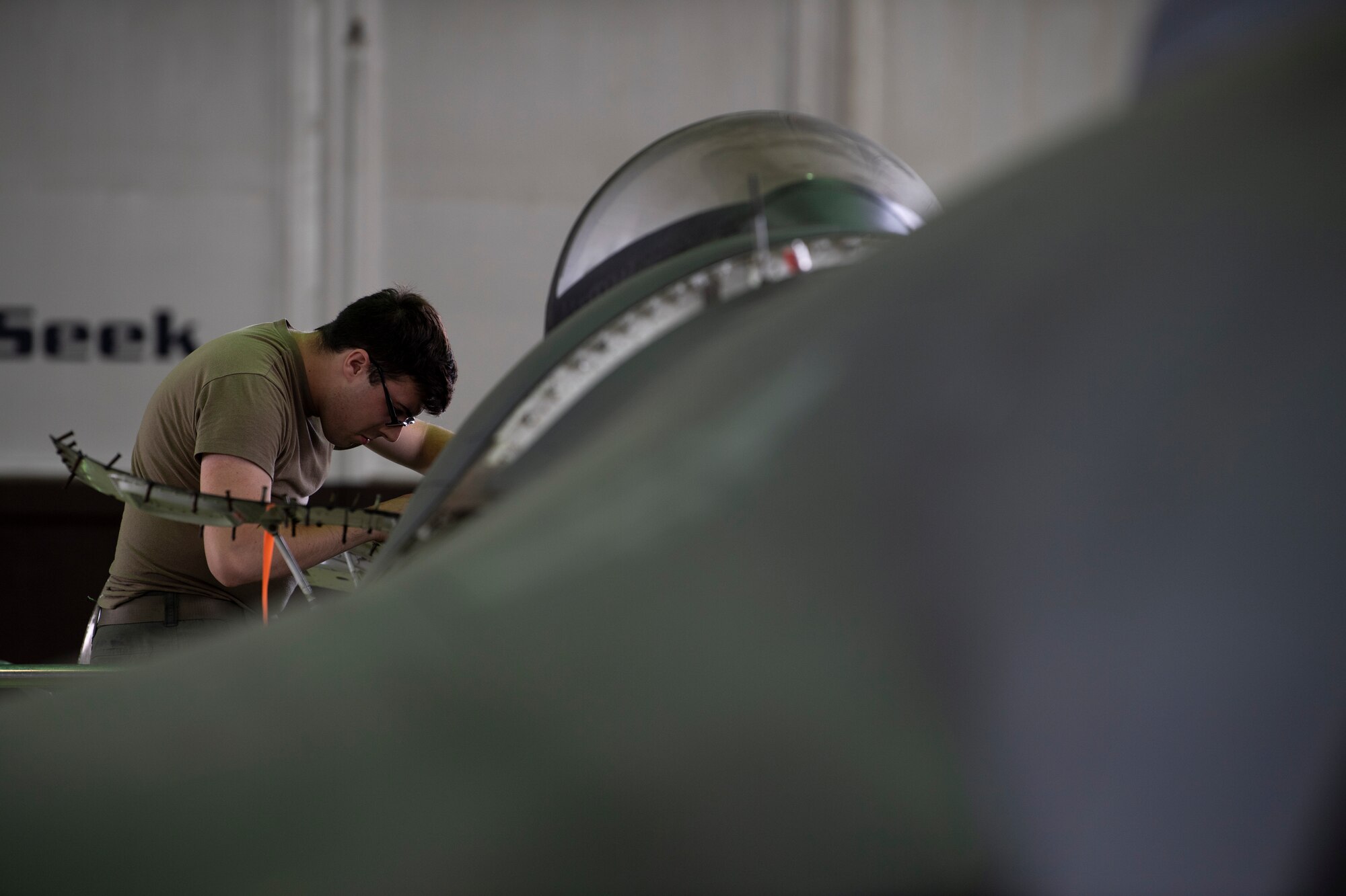 U.S. Air Force Airman performs maintenance on an F-16C Fighting Falcon.