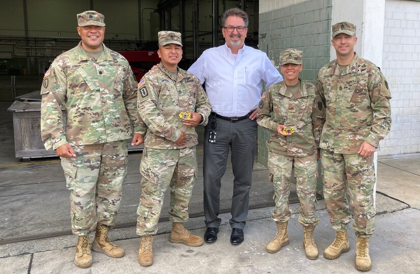 Sergeant 1st Class Jorje Vasquez and Staff Sgt. Julieth Zuleta receive 405th Army Field Support Brigade command coins for excellence recently at the Coleman Army Prepositioned Stocks-2 worksite in Mannheim, Germany. (Courtesy photo)