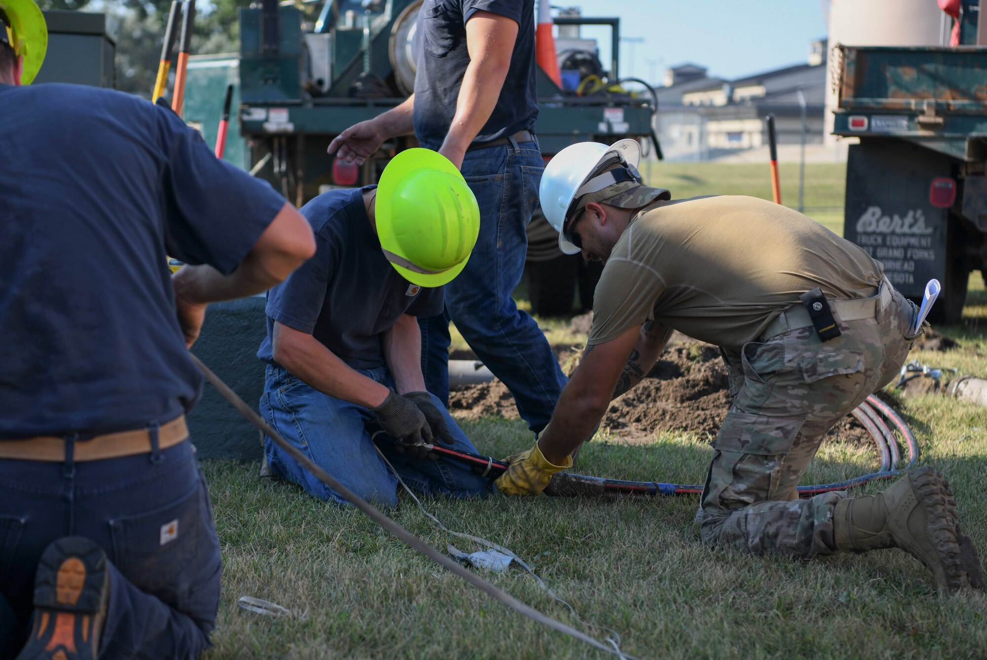 Airmen from the 319th Civil Engineer Squadron and Nodak Electric Cooperative contractors replace high-voltage electrical wiring Aug. 23, 2022, on Grand Forks Air Force Base, North Dakota. The 319th CES supported Nodak in modifying a high and low voltage circuit to convert the generator from a single phase to a three-phase creating a greater electrical supply. (U.S. Air Force photo by Senior Airman Roxanne A. Belovarac)
