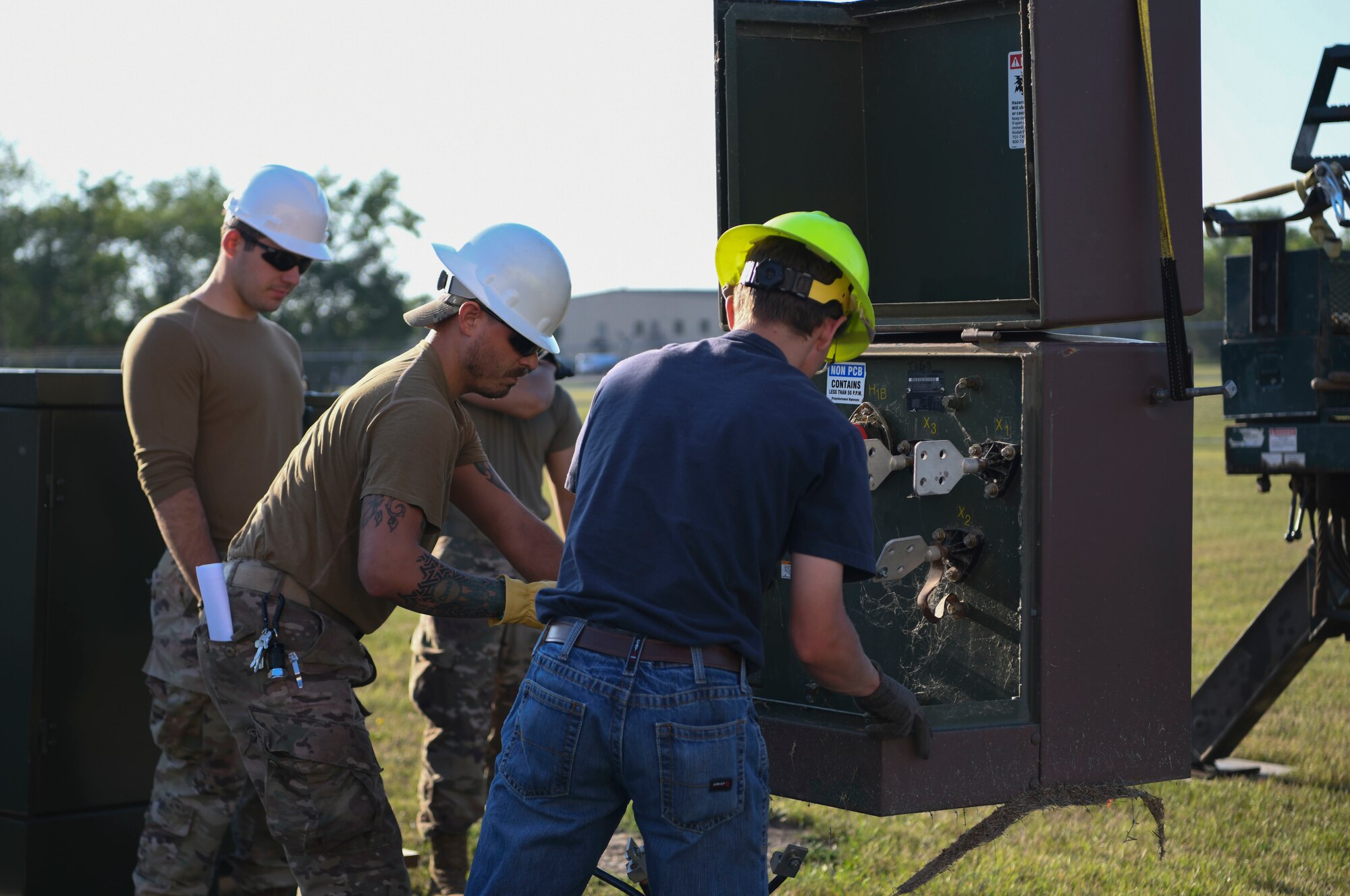 Airmen from the 319th Civil Engineer Squadron and Nodak Electric Cooperative contractors replace high-voltage electrical wiring Aug. 23, 2022, on Grand Forks Air Force Base, North Dakota. The installation project allowed the existing mission infrastructure to be upgraded and created training opportunities for the 319th CES airmen. (U.S. Air Force photo by Senior Airman Roxanne A. Belovarac)