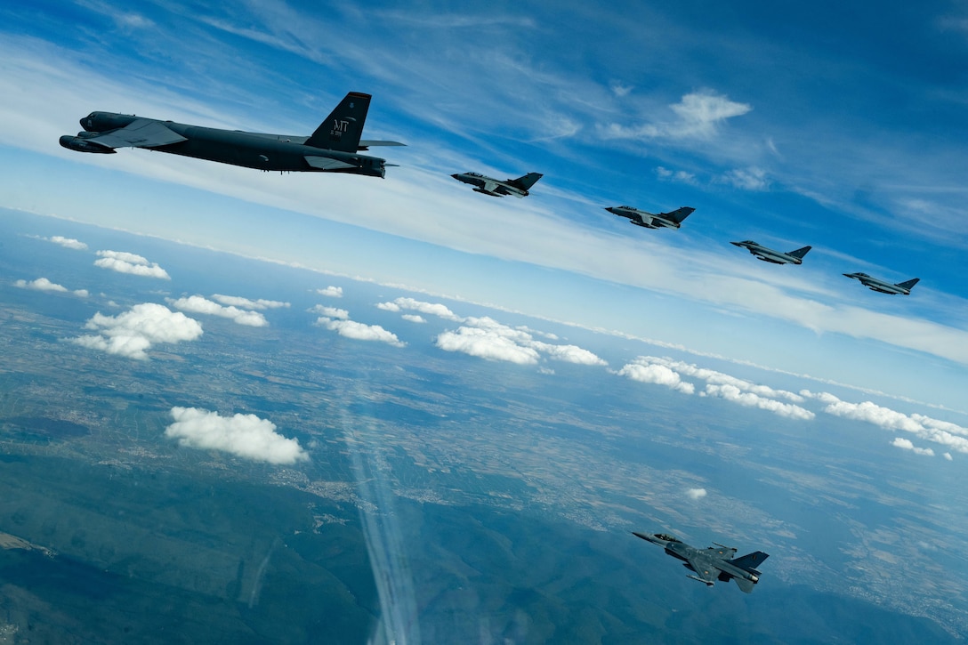 Six aircraft fly in formation.