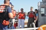 Research and Development Center (RDC) interns (from right) Victoria Beke, Midshipman Ryan Grafman, Stephanie Searing and Connor Bluedorn learn about how search and rescue missions are conducted at Station New London before boarding a 45-foot response boat medium to see the station’s area of operation on the Thames River in July 2022. (U.S. Coast Guard photo)