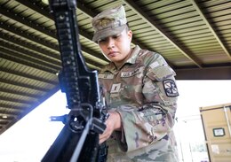 Soldier assembles an M240B machine gun