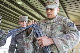 Soldiers assemble an M240B machine gun