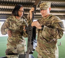 Soldiers reassemble an M240B machine gun