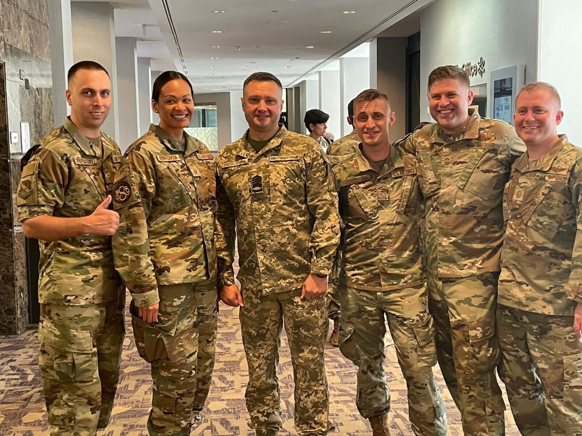 From left, U.S. Air Force Master Sgt. Yuriy Papayanki, 97th Healthcare Operations Squadron medical administration technician, poses for a photo with Kostiantyn Stanislavchuk, Chief Master Sergeant of the Ukrainian Air Force and others at the Senior Enlisted Leader International Summit in Arlington, Va., Aug. 1, 2022. Papayanki directly supported bilats at the Pentagon with the Sgt. Maj. of the Army, Deputy Master Chief Petty Officer of the Navy, Chief Master Sergeant of Space Force, Undersecretary of the Air Force for International Affairs, and a multitude of international Chief Master Sergeant of the Air Force equivalents. (Courtesy photo by Master Sgt. Yuriy Papayanki)