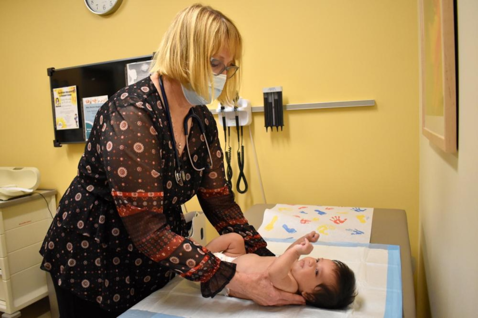 female doctor examining a baby