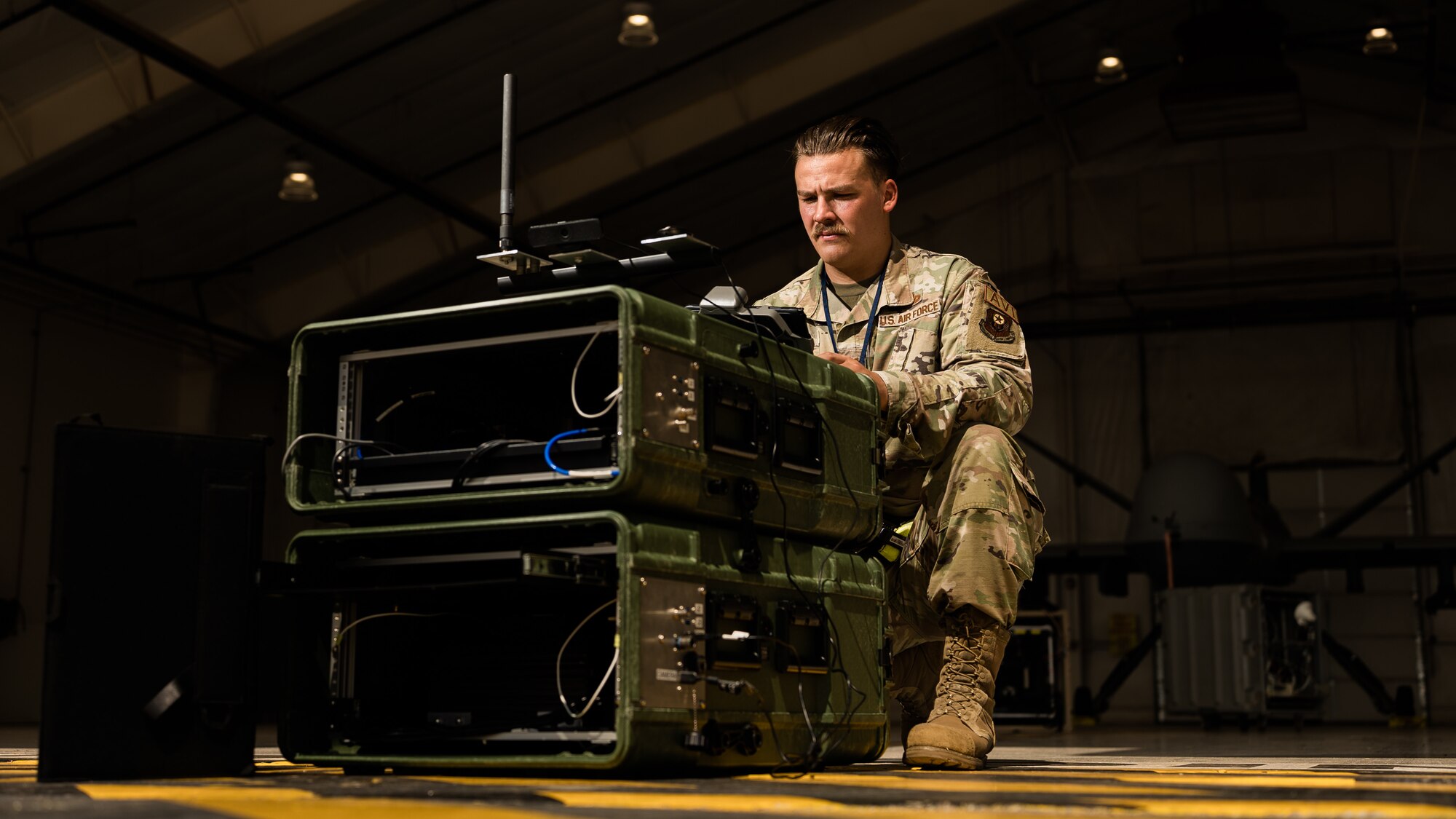 An Air Force Technical Sergeant operates a piece of maintenance equipment.