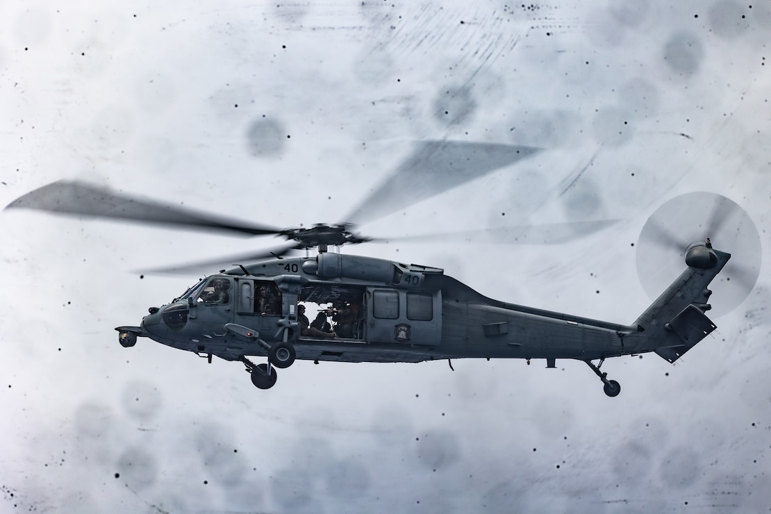 A U.S. Marine Corps scout sniper with Battalion Landing Team 2/5, 31st Marine Expeditionary Unit, provides over watch from a U.S. Navy SH-60 Sea Hawk, with Helicopter Sea Combat Squadron 23 Wildcards, Amphibious Assault Ship USS Tripoli in support of a visit board search and seizure exercise aboard Expeditionary Mobile Base USS Miguel Keith in the Philippine Sea, Aug. 17, 2022. The 31st MEU maintains the capability to seize and clear ships while at sea to protect themselves and allies in the Indo-Pacific Region. The 31st MEU is operating aboard ships of the Tripoli Amphibious Ready Group in the 7th Fleet area of operations to enhance interoperability with allies and partners and serve as a ready response force to defend peace and stability in the INDOPACOM region.