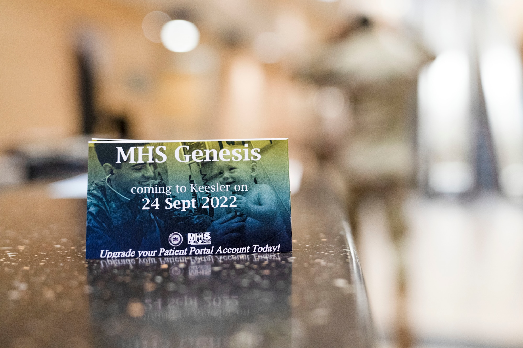 A Military Health System GENESIS informational card is displayed in the front lobby of the the 81st Medical Group at Keesler Air Force Base, Mississippi. MHS GENESIS will become Keesler Medical Center's new electronic health system that will serve as a standardization across all DoD health care facilities. (U.S. Air Force photo by Airman 1st Class Trenten Walters)
