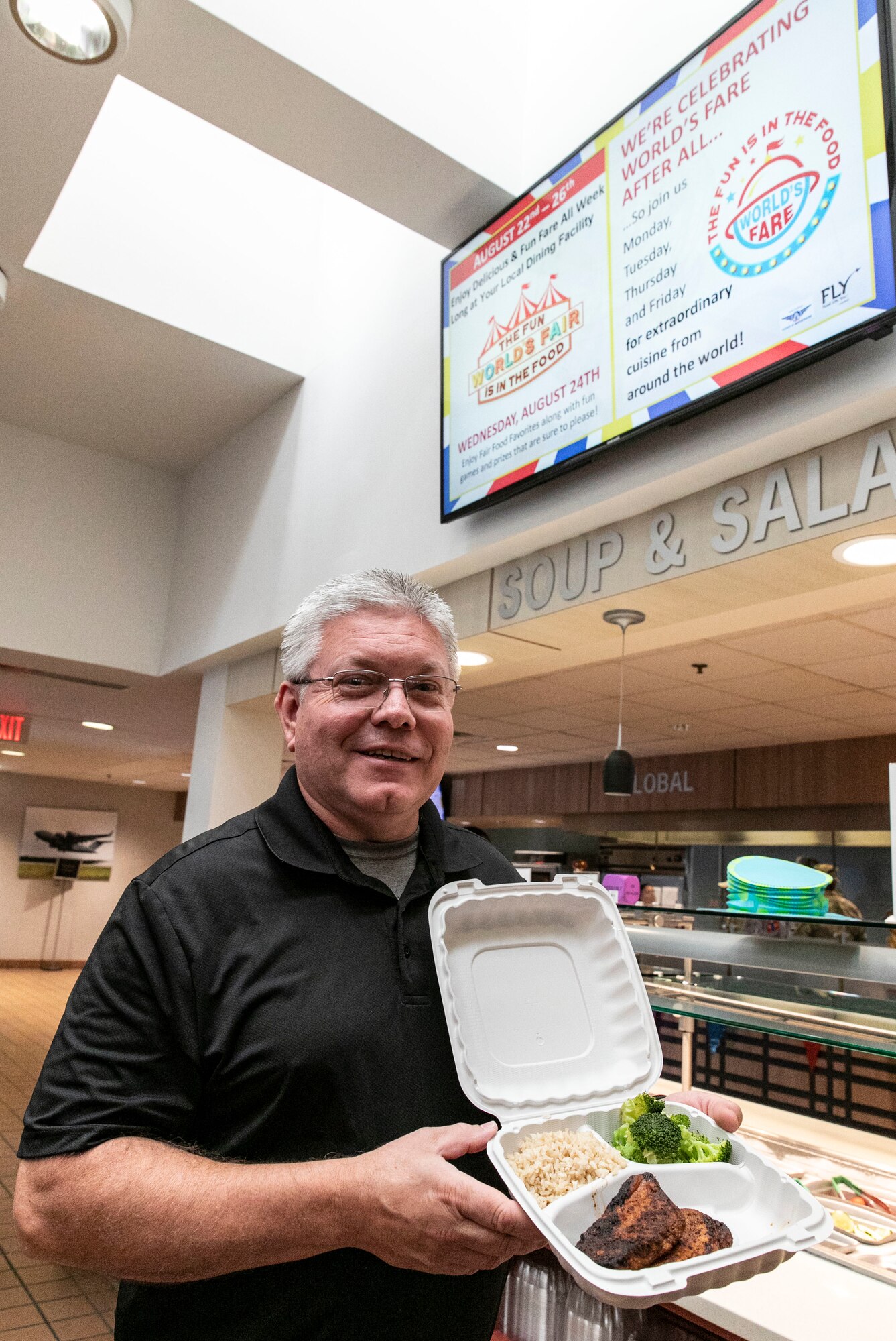 Dave Johnson, 436th Airlift Wing inspector general complaints resolution director, displays his German inspired cuisine in a to-go container at the Patterson Dining Facility on Dover Air Force Base, Delaware, Aug. 25, 2022. Each day during the week of Aug. 22-26, personnel assigned to the 436th Force Support Squadron dining facility prepared food from different regions of the world for lunch to promote diversity during National Foreign Language Observation week. (U.S. Air Force photo by Roland Balik)