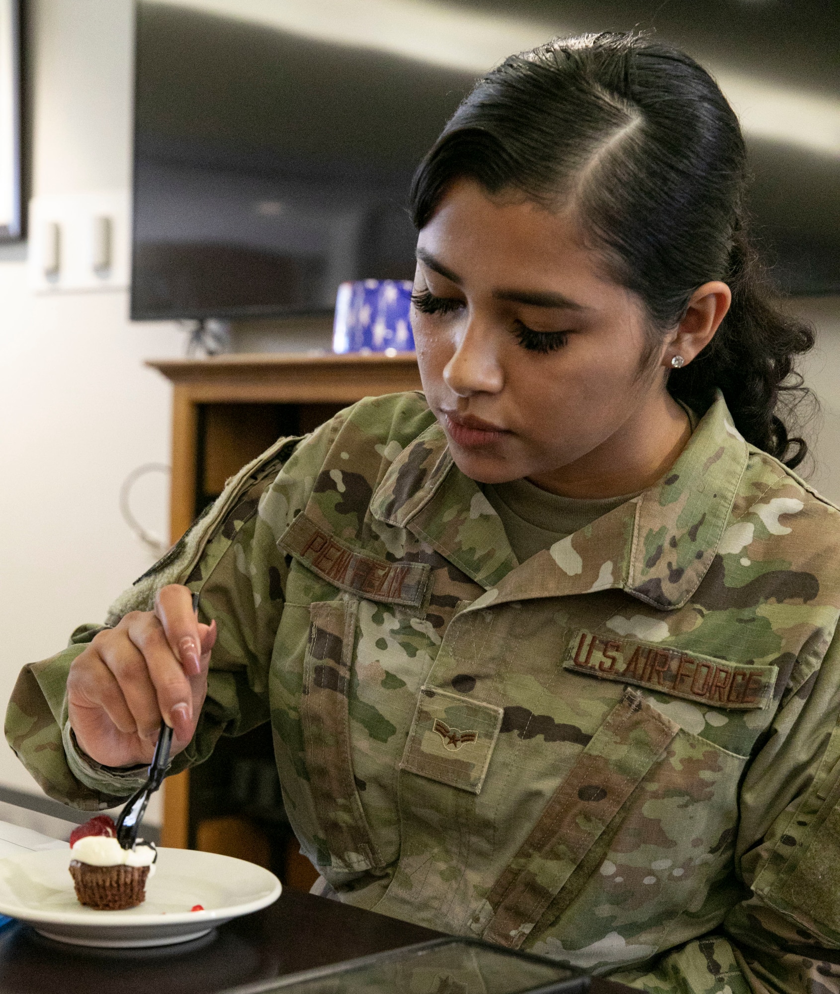 Airman 1st Class Angie Pena-Felix, Air Force Mortuary Affairs Operations Fisher House manager, samples one of the desserts entered in The Great Diversity Dessert Bake-Off Challenge held at the Patterson Dining Facility on Dover Air Force Base, Delaware, Aug. 24, 2022. Pena-Felix was one of four judges for the challenge, which was part of the 436th Force Support Squadron’s National Foreign Language Observation week. (U.S. Air Force photo by Roland Balik)