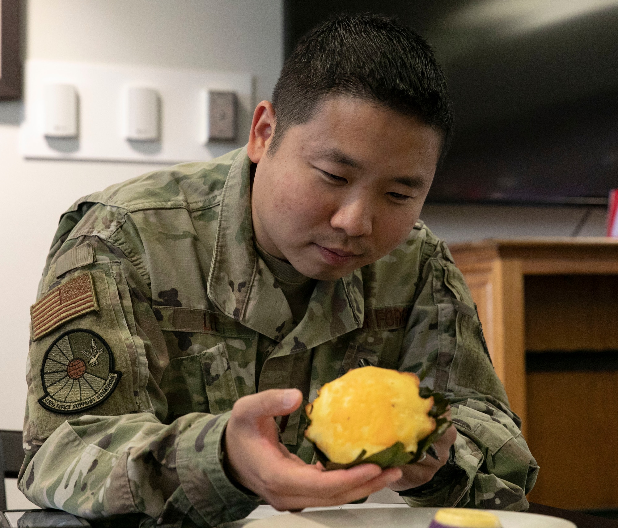 Capt. Benjamin Lee, 436th Force Support Squadron operations officer, examines a dessert entered in The Great Diversity Dessert Bake-Off Challenge held at the Patterson Dining Facility on Dover Air Force Base, Delaware, Aug. 24, 2022. Lee was one of four judges for the challenge, which was part of the 436th Force Support Squadron's National Foreign Language Observation week. (U.S. Air Force photo by Roland Balik)