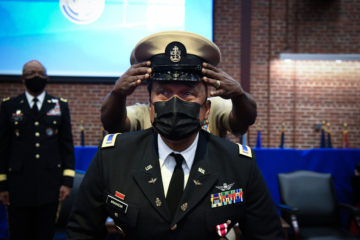 RICHMOND, Virginia (July 29th, 2022) Navy Reserve Force Master Chief (FORCM) Tracy Hunt places a Navy Chief combination cover on Army Chief Warrant Officer 5 Phillip M. Brashear, son of the late Master Chief Master Diver Carl Brashear during his appointment as an Honorary Navy Chief Petty Officer. The appointment was held in conjunction with CW5 Brashear’s retirement ceremony celebrating his 40 years of military service at the Frank B. Lotts Conference Center onboard Defense Supply Center in Richmond, Virginia on July 29th, 2022. CW5 Brashear was appointed as an Honorary Navy Chief Petty Officer by the Master Chief Petty officer (MCPON) of the Navy Russell Smith for his relentless dedication to the United States Navy. Over the course of 17 years, CW5 Brashear inspired Sailors and members of the Chiefs Mess to keep pushing forward in the face of adversity, volunteering his service to the Navy, and accepting responsibility beyond the call of printed assignment.. (U.S. Navy photo by Mass Communications Specialist 2nd Class Alexa Trafton)