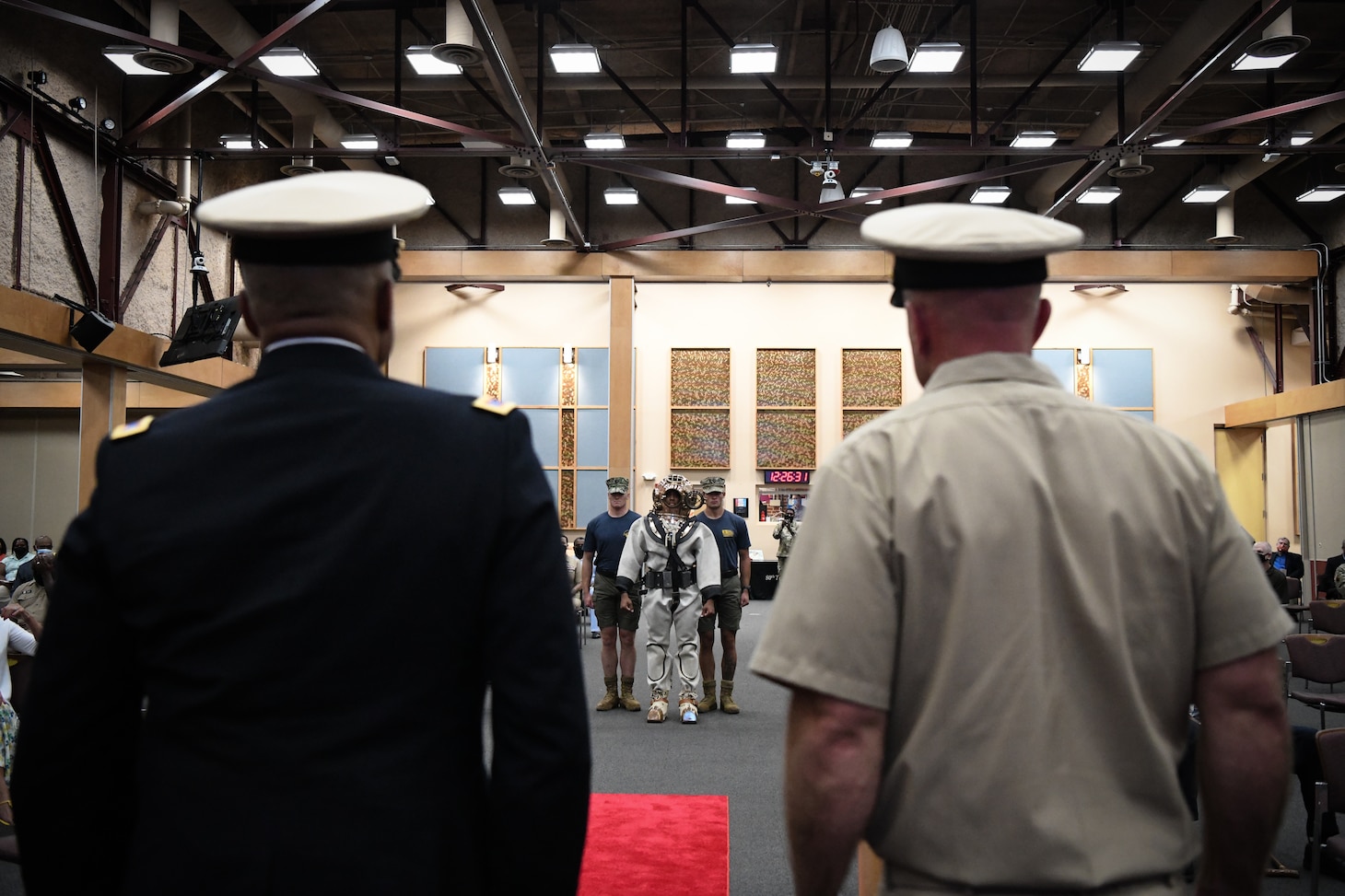 RICHMOND, Virginia (July 29th, 2022) Army Chief Warrant Officer 5 and Honorary Navy Chief, Phillip M. Brashear stands beside Command Master Chief (CMDCM) Jason Cook of Mobile Diving and Salvage Unit (MDSU) as three Navy Divers make their way down the aisle to render CW5 Brashear his final salute, during his 40-year retirement ceremony held at the Frank B. Lotts Conference Center onboard Defense Supply Center in Richmond, Virginia on July 29th, 2022. CW5 Brashear was appointed as an Honorary Navy Chief Petty Officer by the Master Chief Petty officer (MCPON) of the Navy Russell Smith for his relentless dedication to the United States Navy. Over the course of 17 years, CW5 Brashear inspired Sailors and members of the Chiefs Mess to keep pushing forward in the face of adversity, volunteering his service to the Navy, and accepting responsibility beyond the call of printed assignment.  (U.S. Navy photo by Mass Communications Specialist 2nd Class Alexa Trafton)