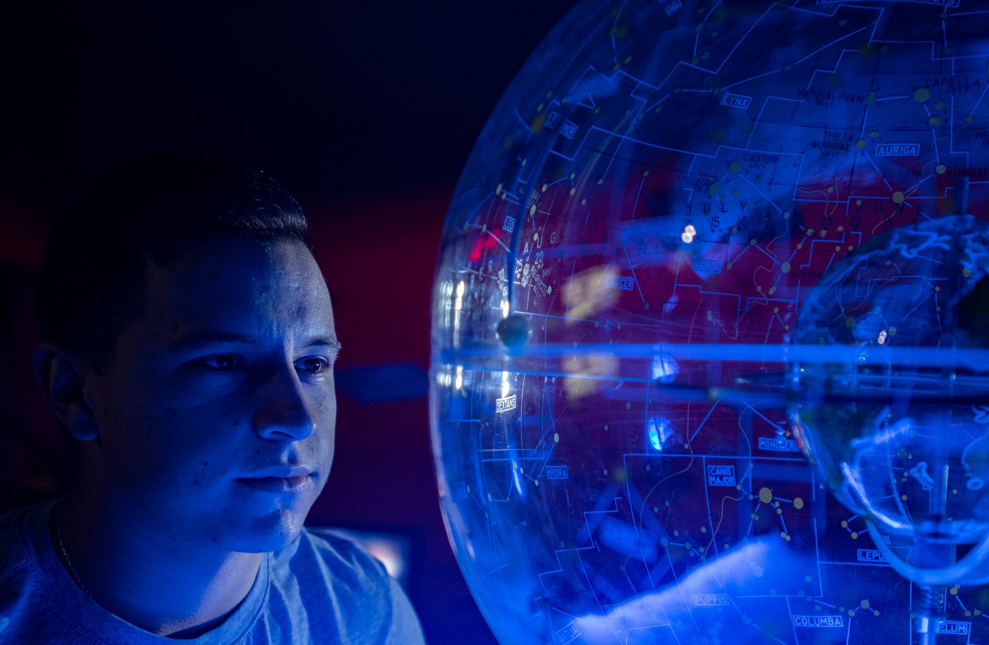 man looking at globe