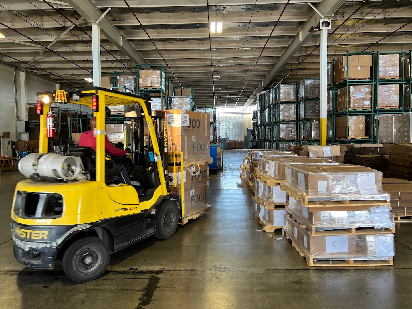 An employee of the Defense Logistics Agency Fire Support Mission aboard DLA Distribution San Joaquin, California, prepares to ship food materiel to the US Forest Service Redding Fire Cache.