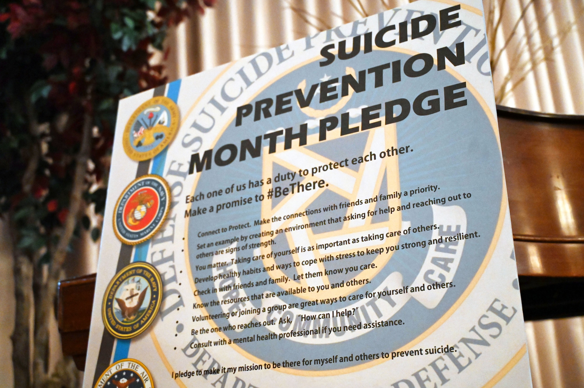 JBMDL leadership pose for a picture in front of the Suicide Prevention declaration.