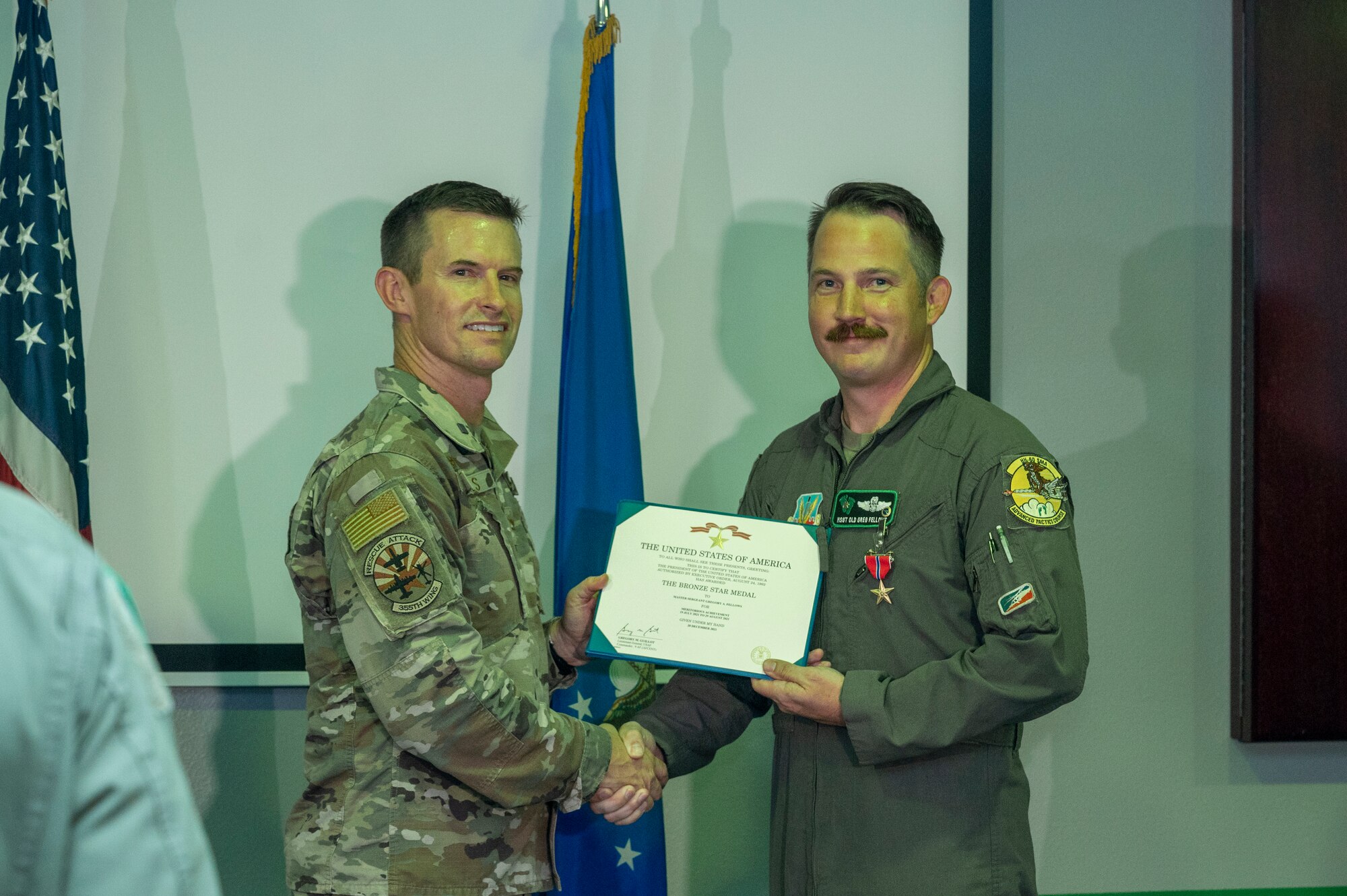 Two men hold a certificate.