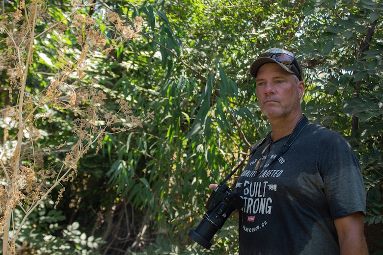 Steve Grasmick, a private firm logistician and amateur bird photographer, quietly and carefully looks for raptors to photograph Aug. 19 at the Sepulveda Dam Recreational Area in Encino California.