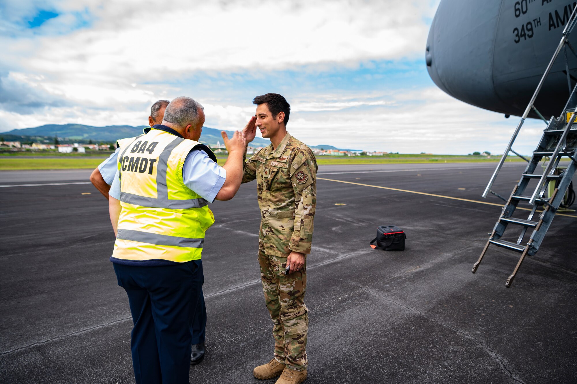 An Airman salutes another military person.