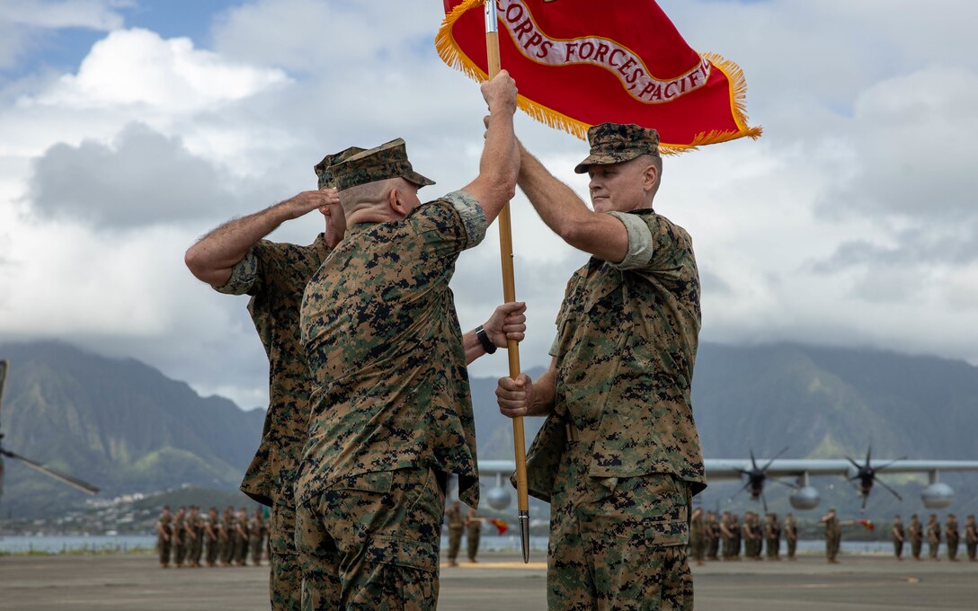 U.S. Marine Corps Lt. Gen. Steven R. Rudder, commander, U.S. Marine Corps Forces, Pacific (MARFORPAC), passes the colors to the incoming commander, Lt. Gen. William M. Jurney, during the MARFORPAC change of command ceremony at Marine Corps Air Station Kaneohe Bay, Marine Corps Base Hawaii, Sept. 7, 2022. Rudder relinquished command to Jurney. With two-thirds of the Marine Corps’ operating forces assigned, MARFORPAC operates in the U.S. Indo-Pacific Command area of responsibility, the largest Geographical Combatant Command in the U.S. Department of Defense. (U.S. Marine Corps photo by Lance Cpl. Haley Fourmet Gustavsen)