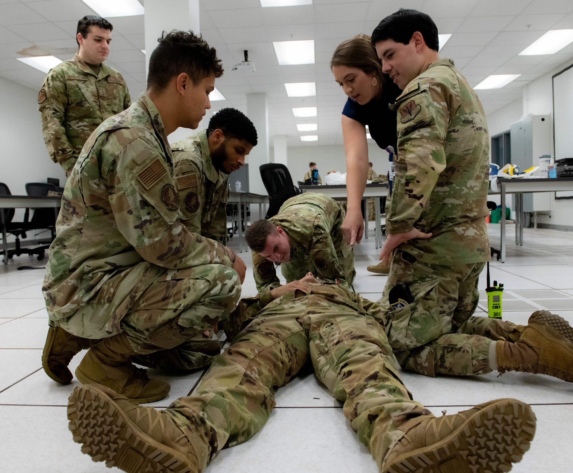 U.S. Air Force Airmen assigned to the 319th Reconnaissance Wing along with a medical professional from the University of North Dakota School of Medicine and Health Sciences Simulation Center practice stabilization techniques during a medical training exercise Aug. 26, 2022, at Grand Forks Air Force Base, North Dakota. During this training event airmen rotated through three training stations with simulated medical emergency scenarios. (U.S. Air Force photo by Senior Airman Phyllis Jimenez)