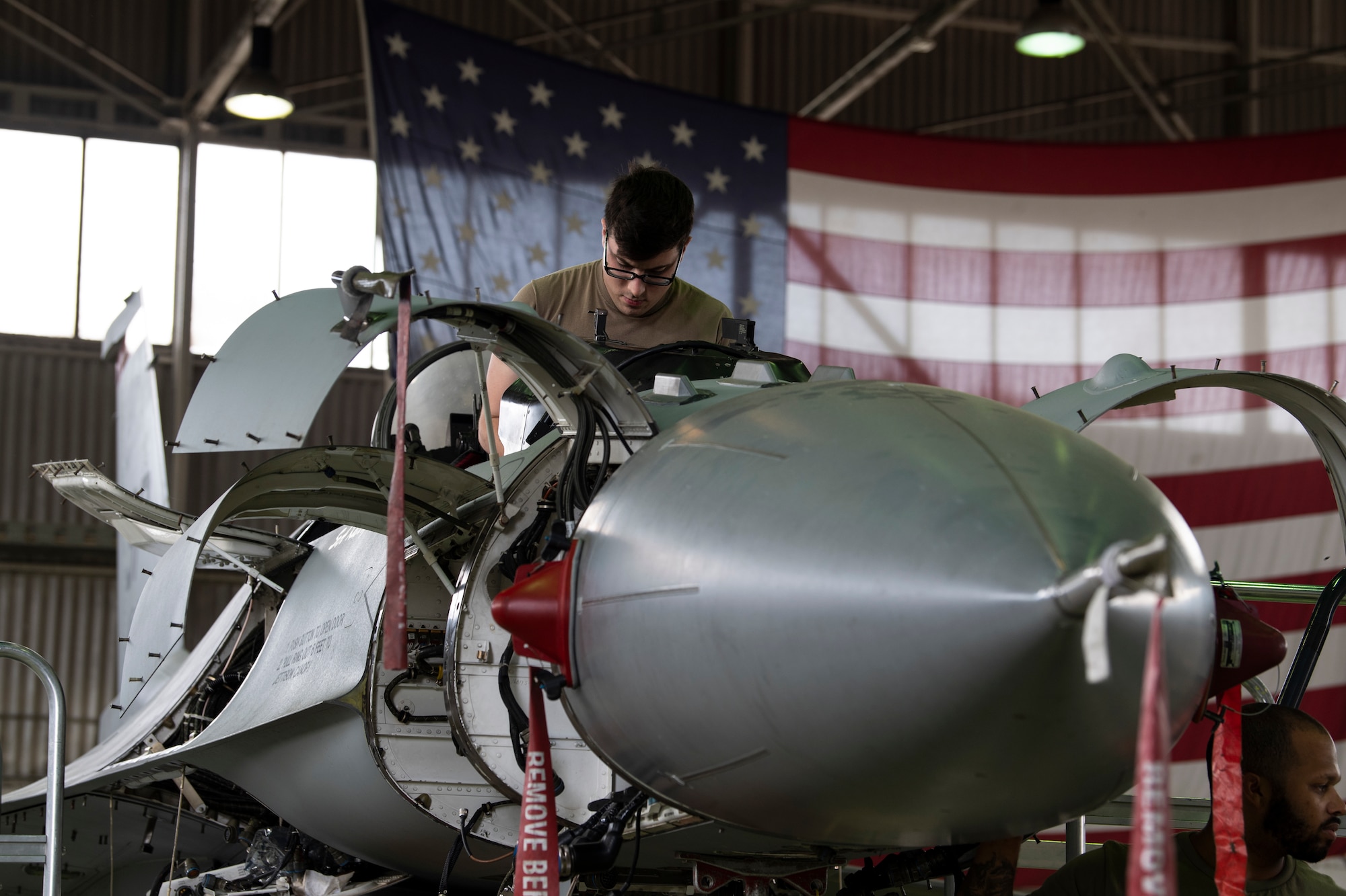 U.S. Air Force Airman performs maintenance on an F-16C Fighting Falcon.