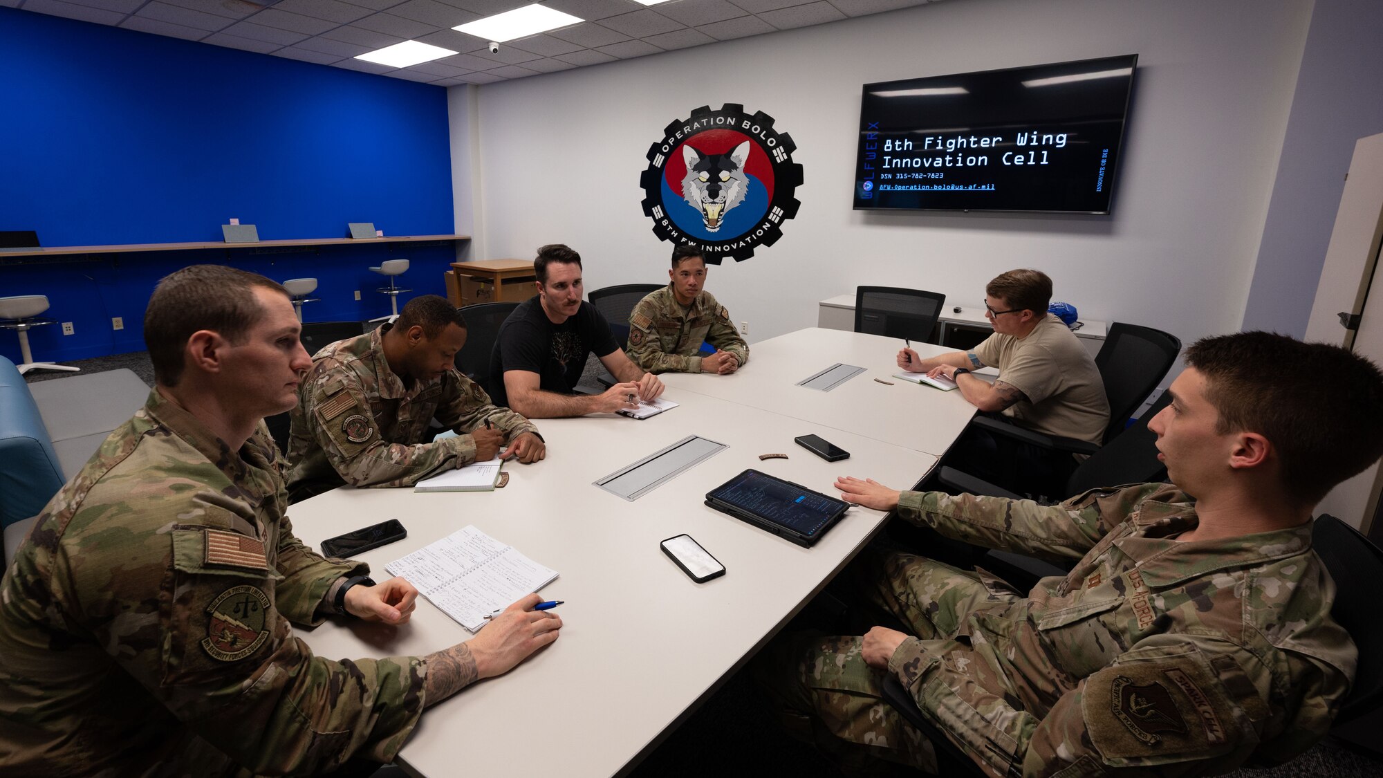 A group of Airmen have a meeting and discuss ideas on how to make WOLFWERX better.
