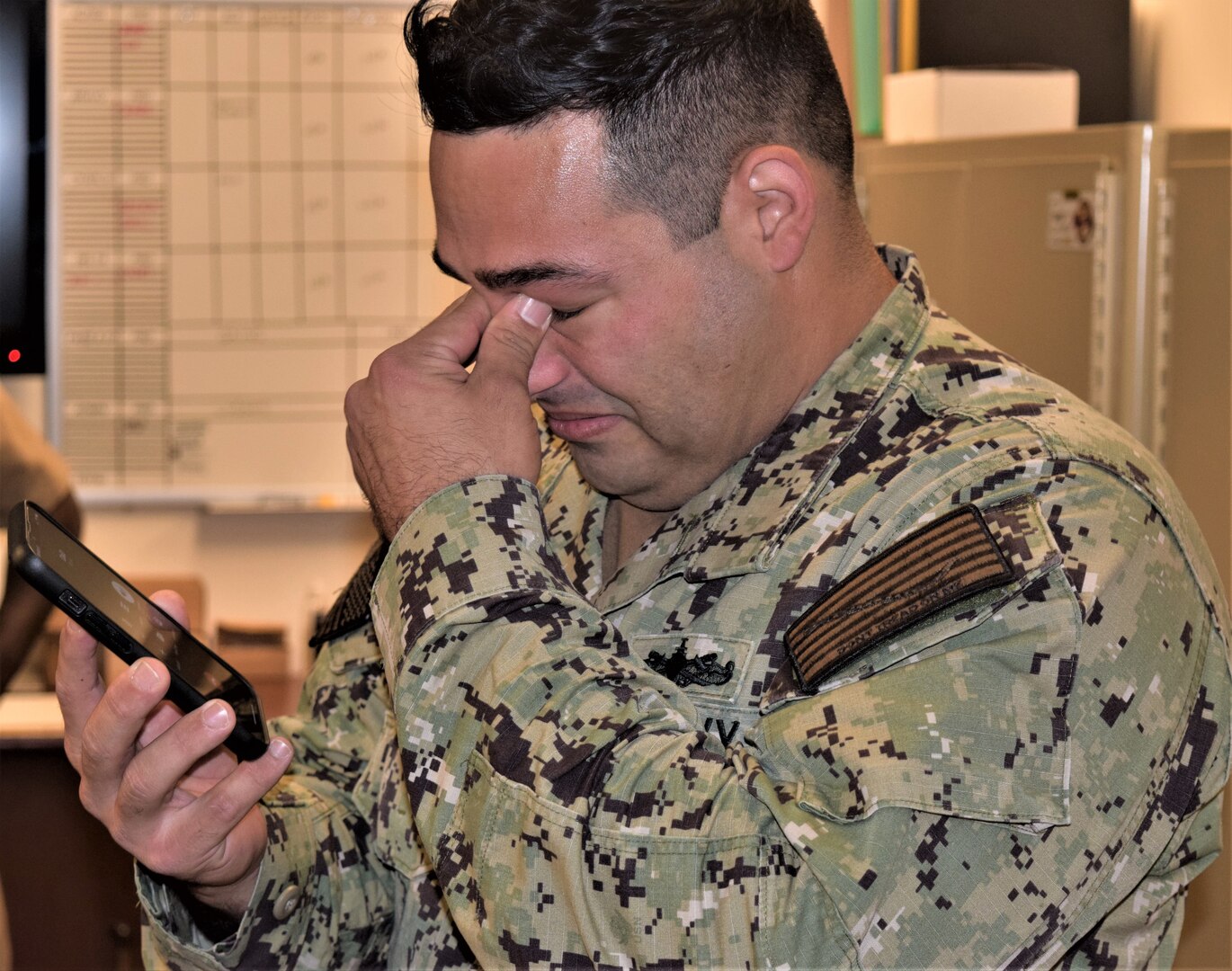 For Gunner’s Mate 1st Class Tristan Brayman, receiving the news he was selected to become a chief petty officer from Capt. Patrick Fitzpatrick, Naval Hospital Bremerton director and NMRTC Bremerton commanding officer and Command Master Chief James B. May, with his wife and son present, he meant immediately called his father, a retired master chief information systems technician, and shared his good news (official Navy photo by Douglas H Stutz, NHB/NMRTC Bremerton public affairs officer).