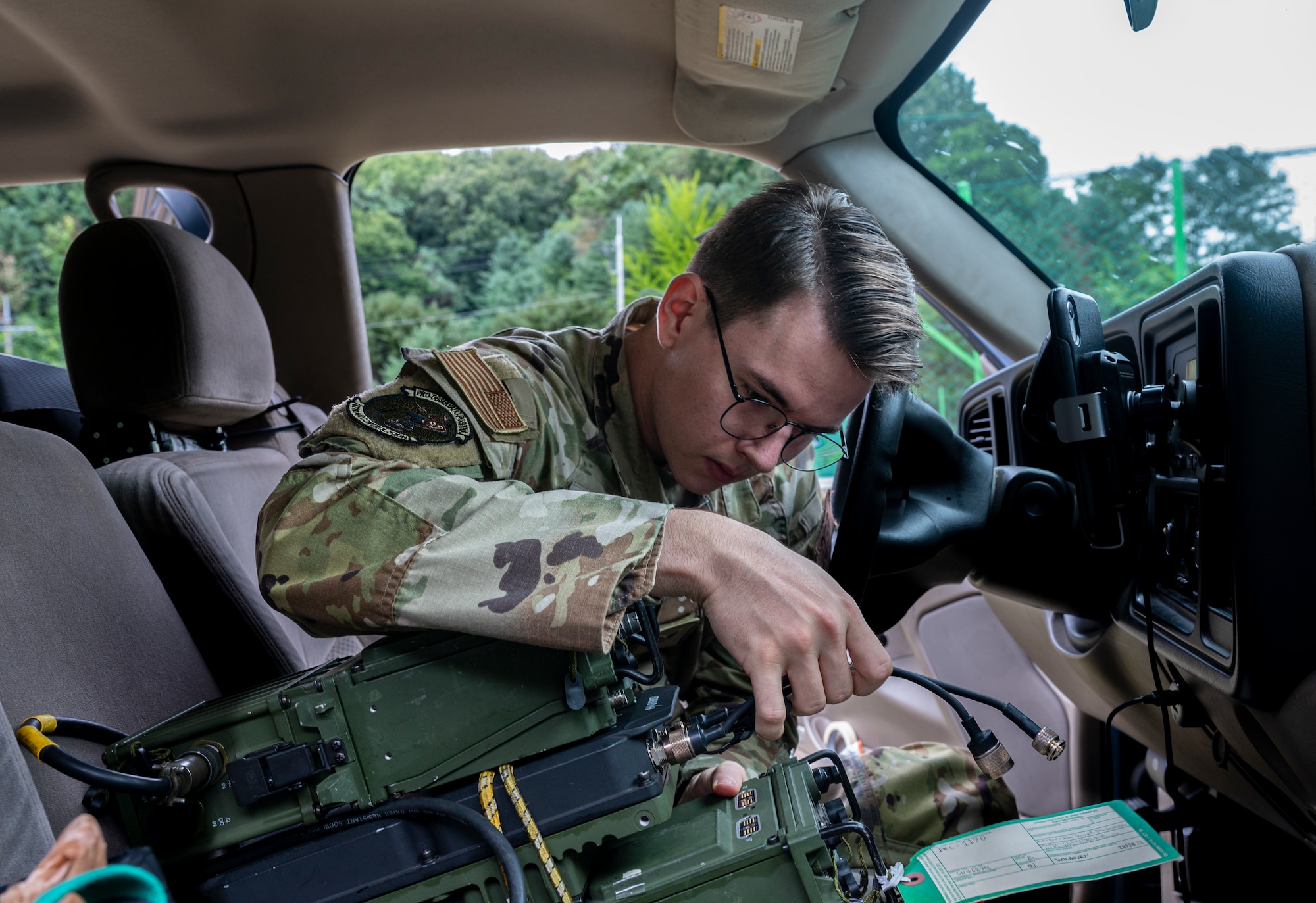 Senior Airman Jonas Cole, 621st Air Control Squadron cyber systems operations technician, connects ultra high frequency radios, in a mobile tactical command and control (C2) vehicle at Yongin Army Base, Republic of Korea, Aug. 31, 2022.